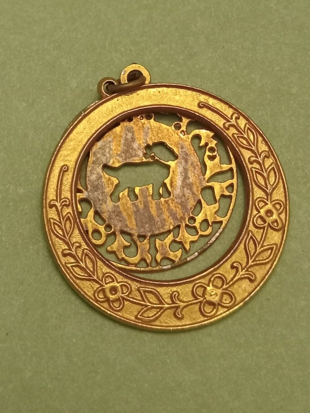 Uniquely detailed vintage gold tone pendant with dog outline inside